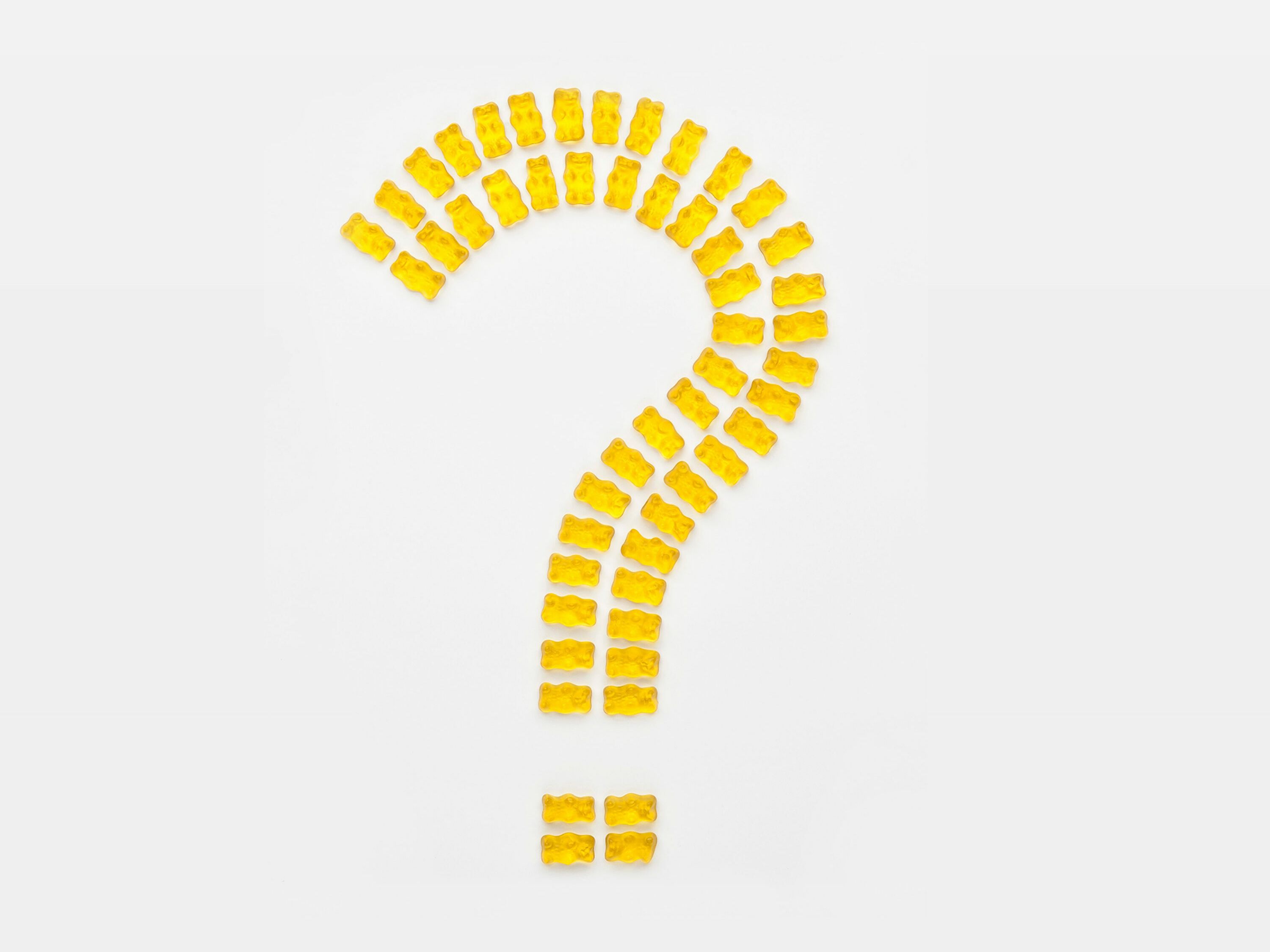 Question mark of yellow Goldbears on light background