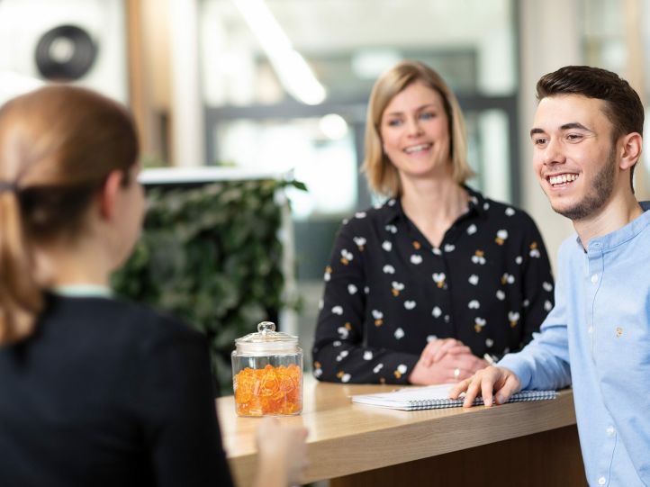 Young employees in conversation with their supervisor at HARIBO