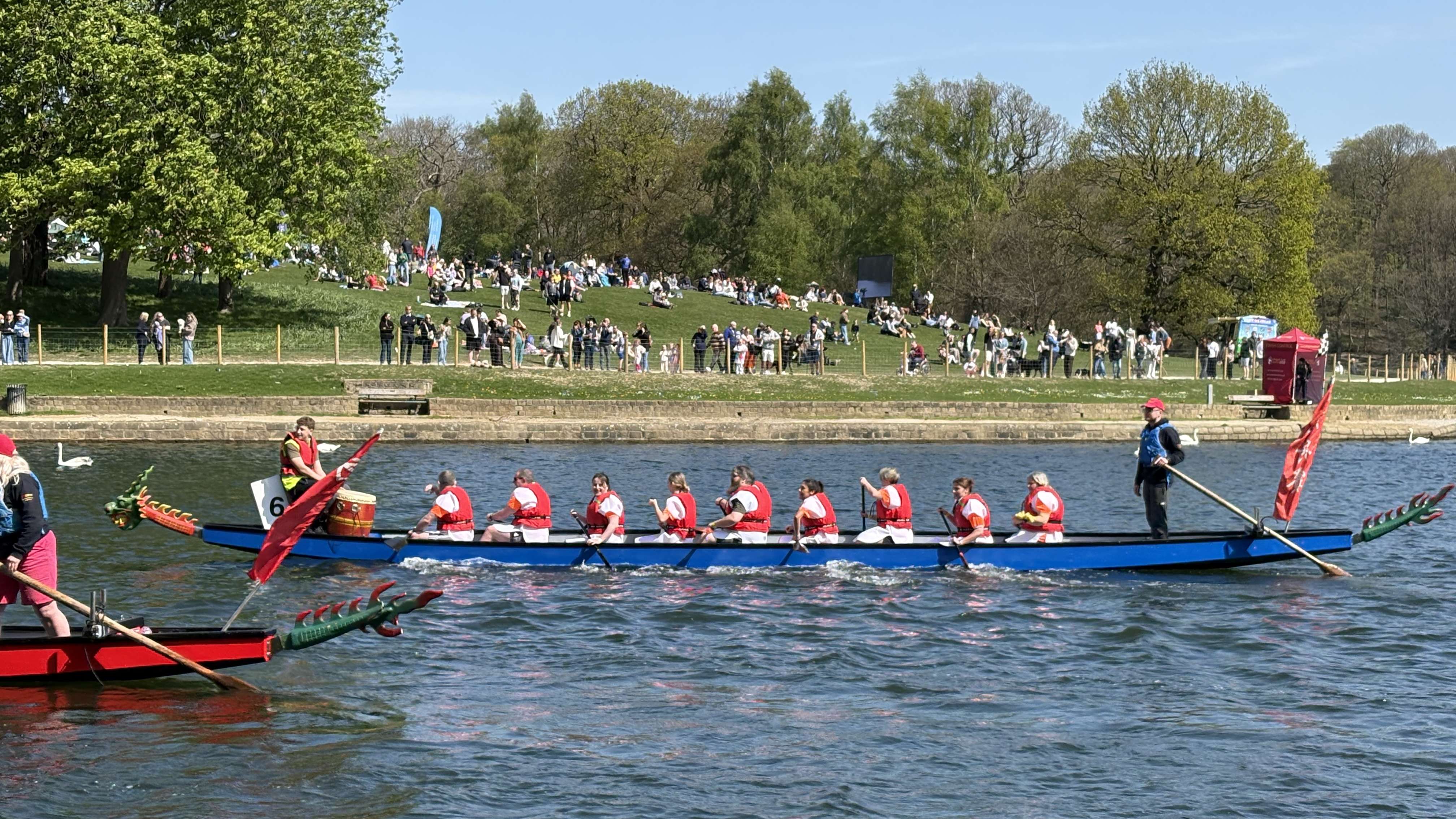 A team of rowers cross the finish line