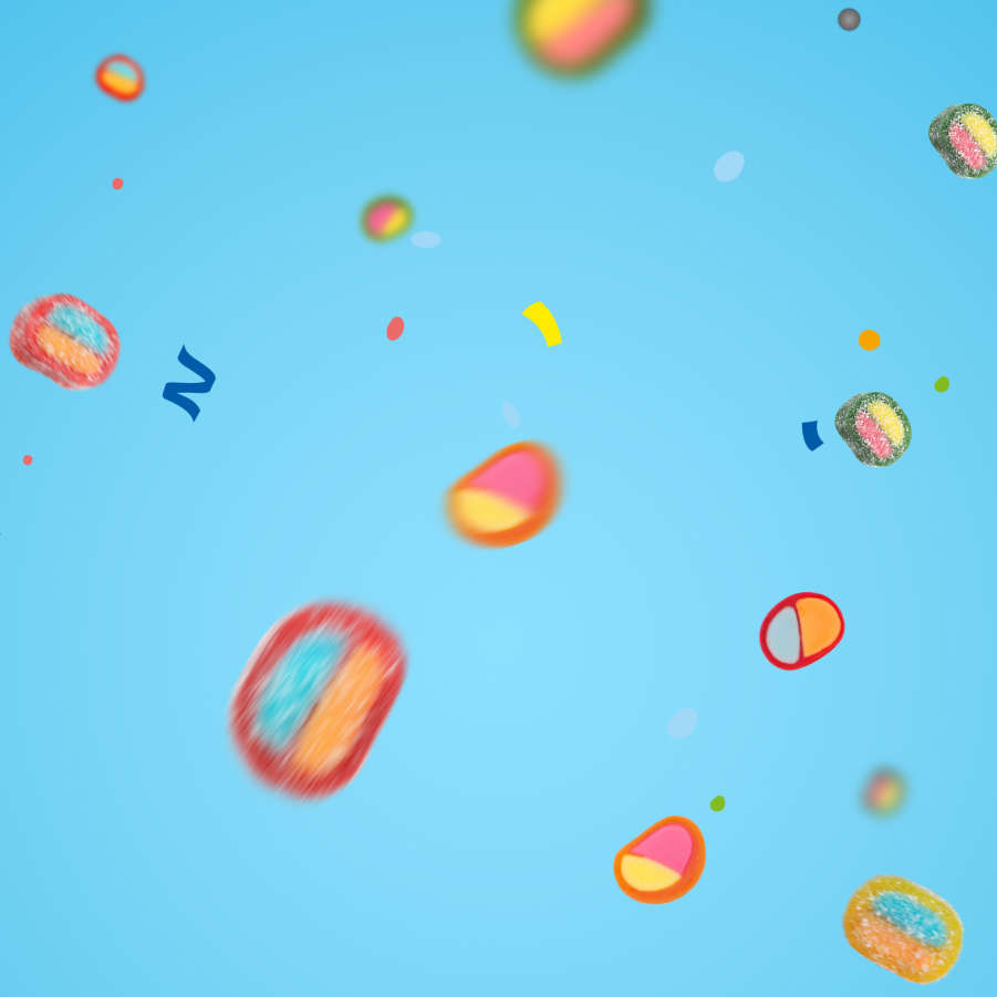 HARIBO Pico-Balla Produktstücke schweben schwerelos vor blauem Hintergrund
