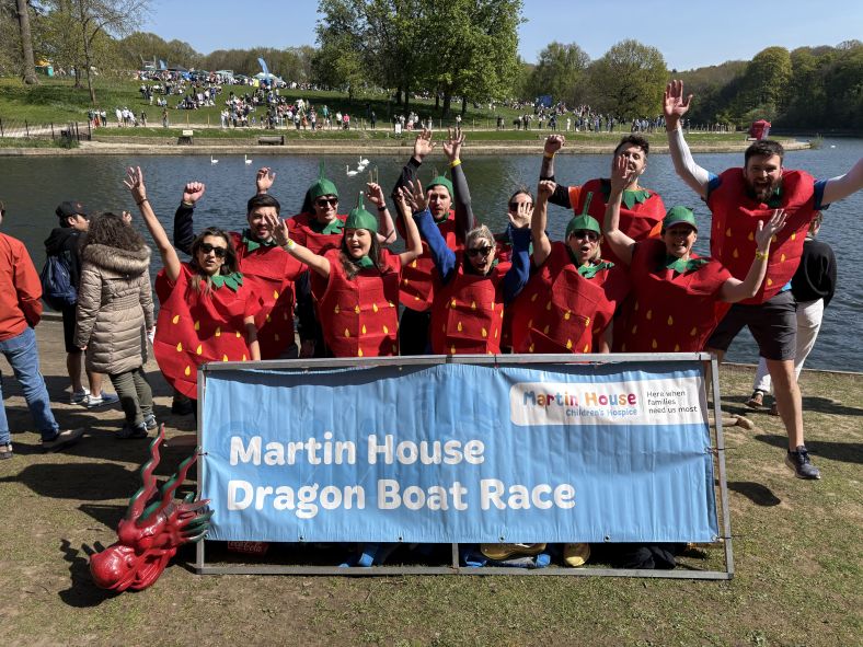 A rowing team dressed as strawberries celebrate