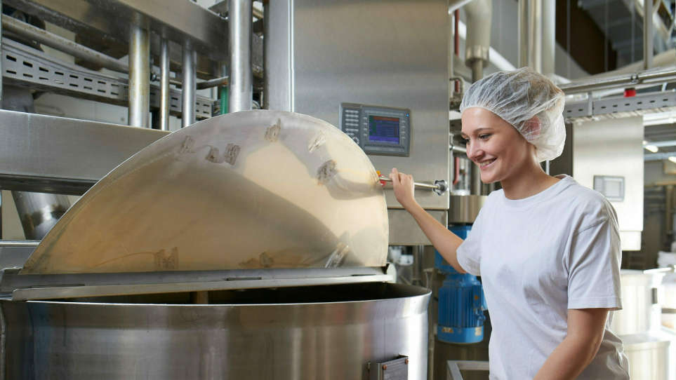 Female employee monitors the production