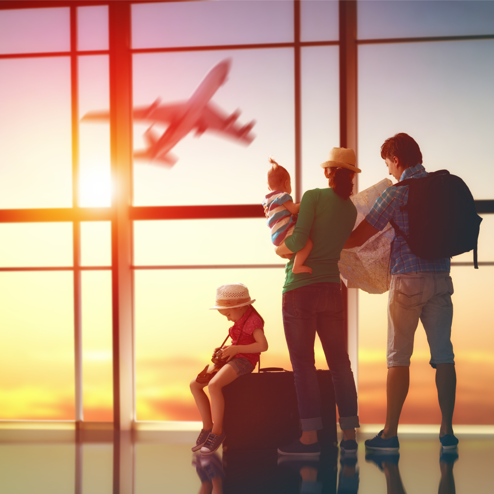 Family watching a plane take of at the airport