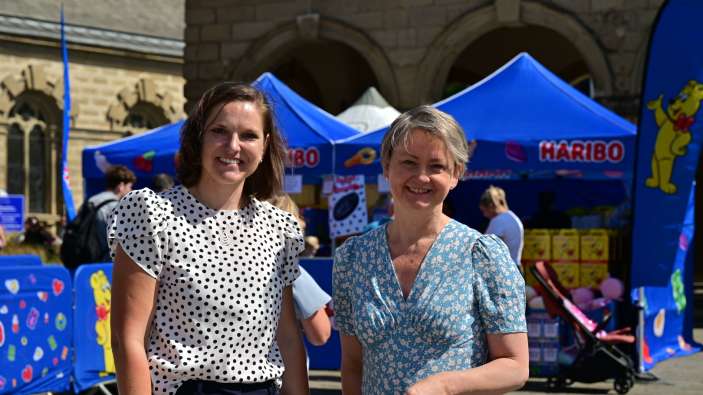 Yvette Cooper and Tabea Powell pose in front of the HARIBO pop-up shop.