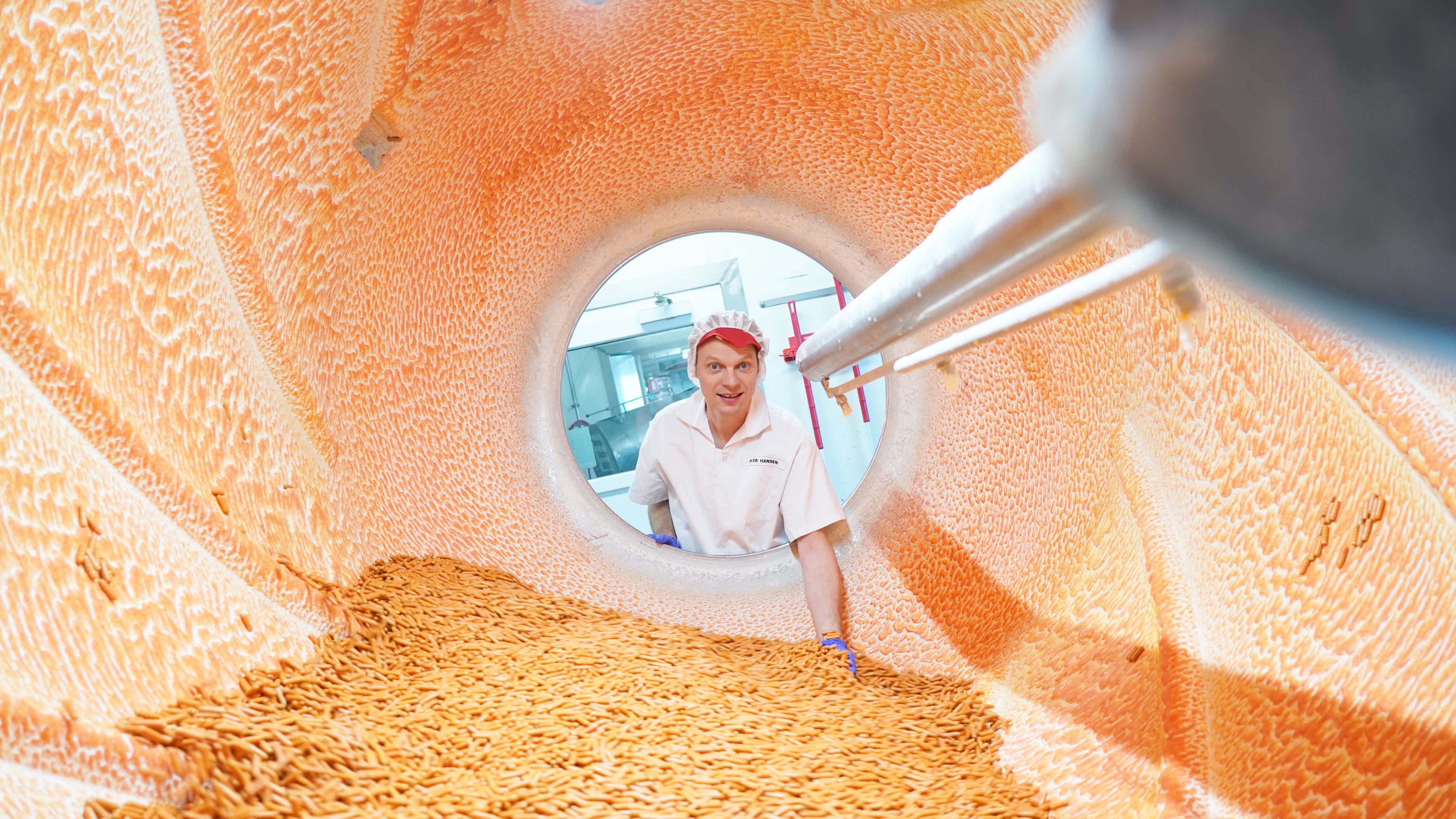 View inside a production vessel, with employee looking in through the opening