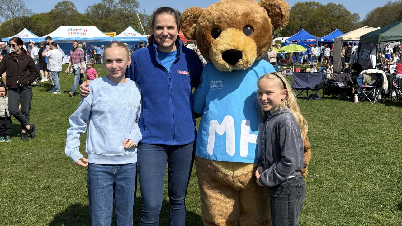 Head of Communications at HARIBO UK, Tabea Powell, poses with the Martin House Mascot with her family.