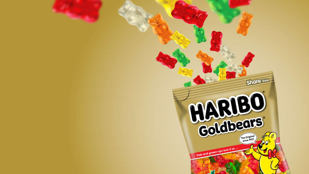 Bag of HARIBO Goldbears and fruit gums on golden background