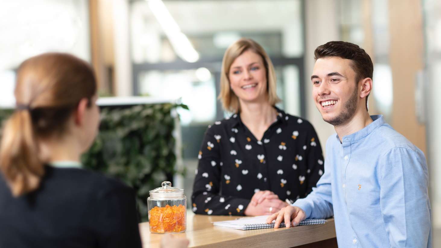 Young employees in conversation with their supervisor at HARIBO