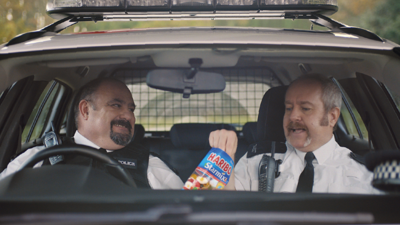 Preview image for tv ad two police officer enjoying HARIBO Starmix