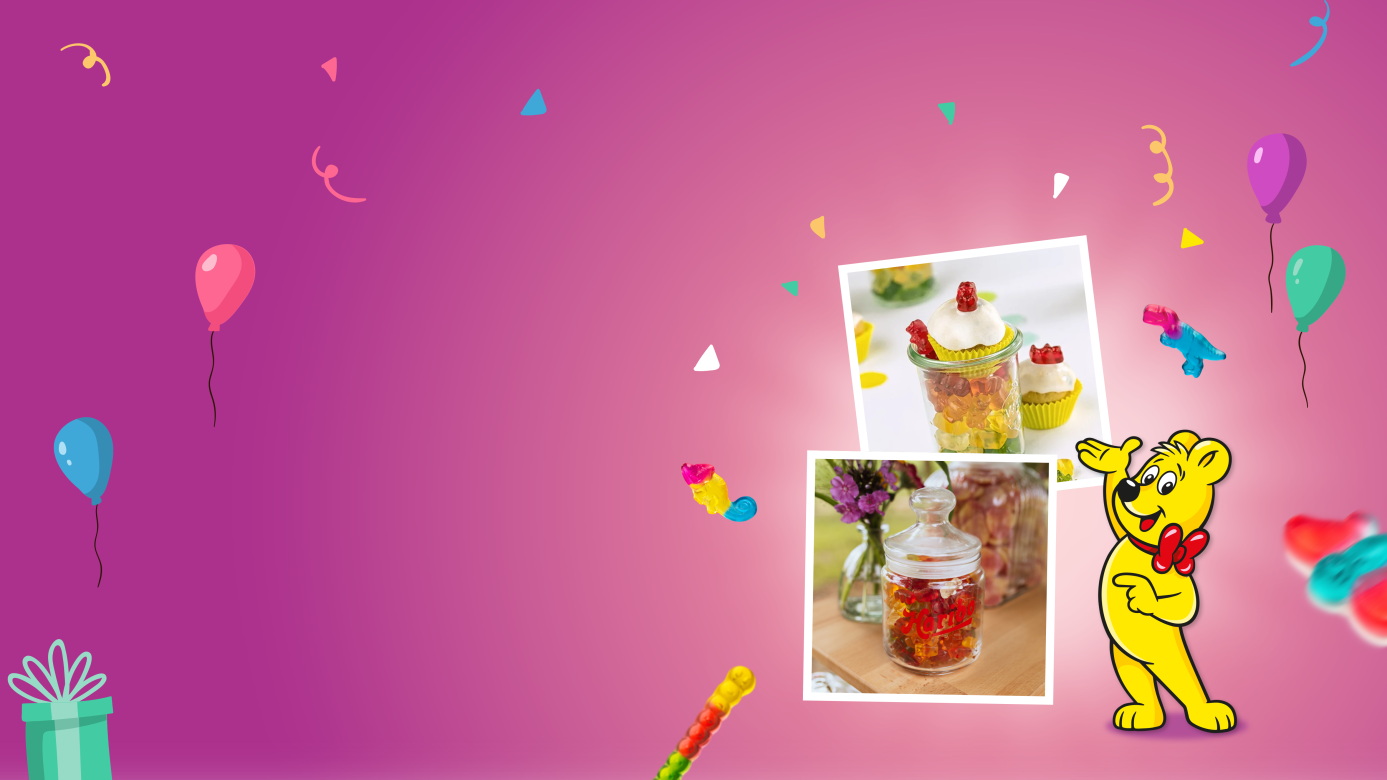 A colorful website header for HARIBO's guide to the best candy bar ideas for any celebration. The pink gradient background features balloons, confetti, and floating gummy bears. Two Polaroid-style photos showcase creative candy table ideas — one displaying cupcakes topped with gummy bears in decorative jars as a charming diy candy bar setup, and the other showing a glass jar filled with HARIBO gummy bears alongside fresh flowers for a rustic candy bar wedding or party look. The HARIBO Goldbear stands beside the photos.