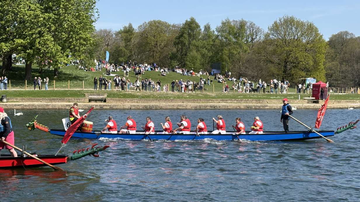 A team of rowers cross the finish line