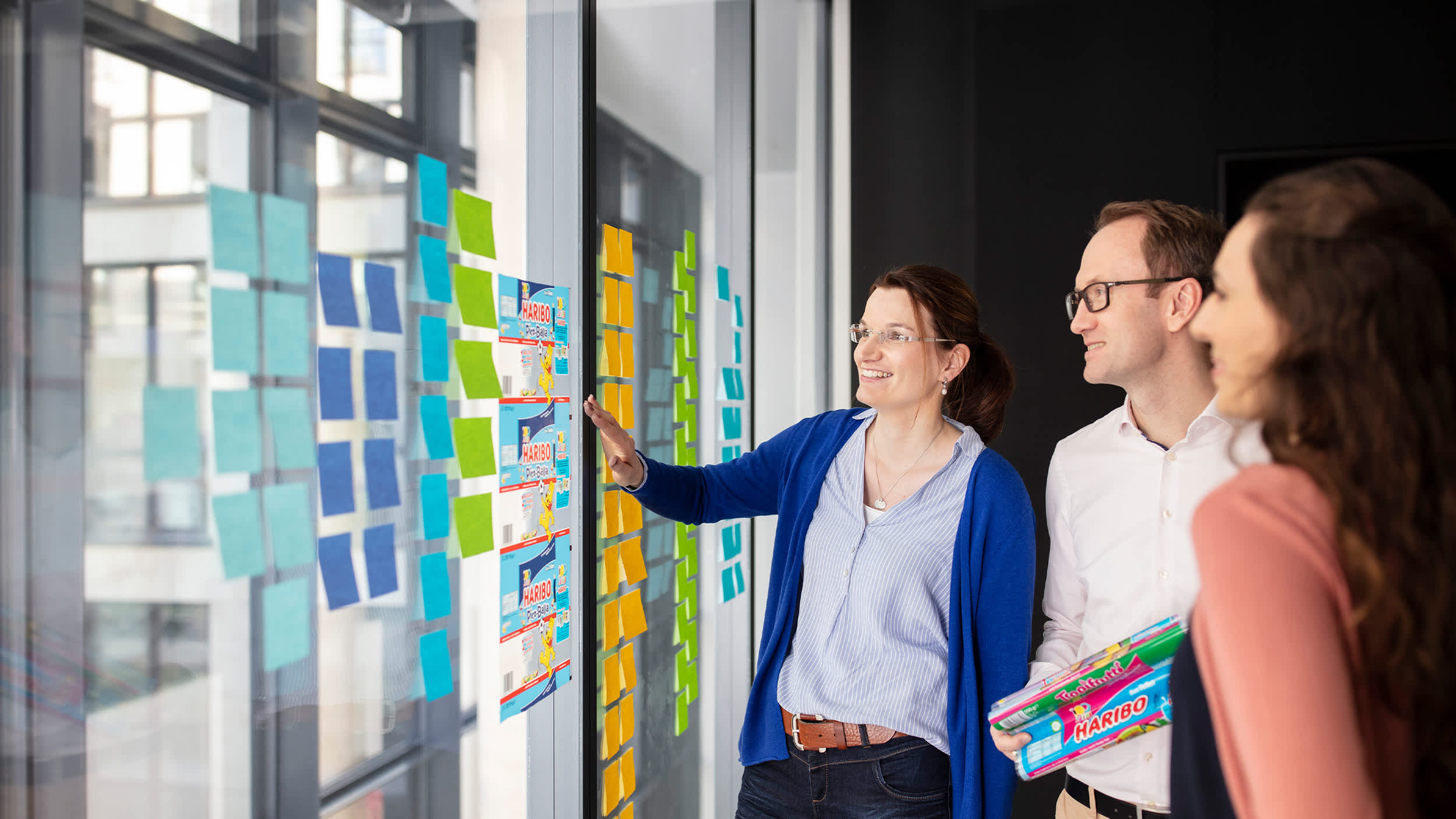 HARIBO-Mitarbeiter vor einer Wand mit bunten Post-its