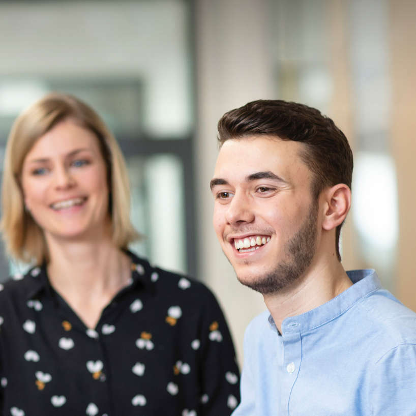 Young employees in conversation with their supervisor at HARIBO