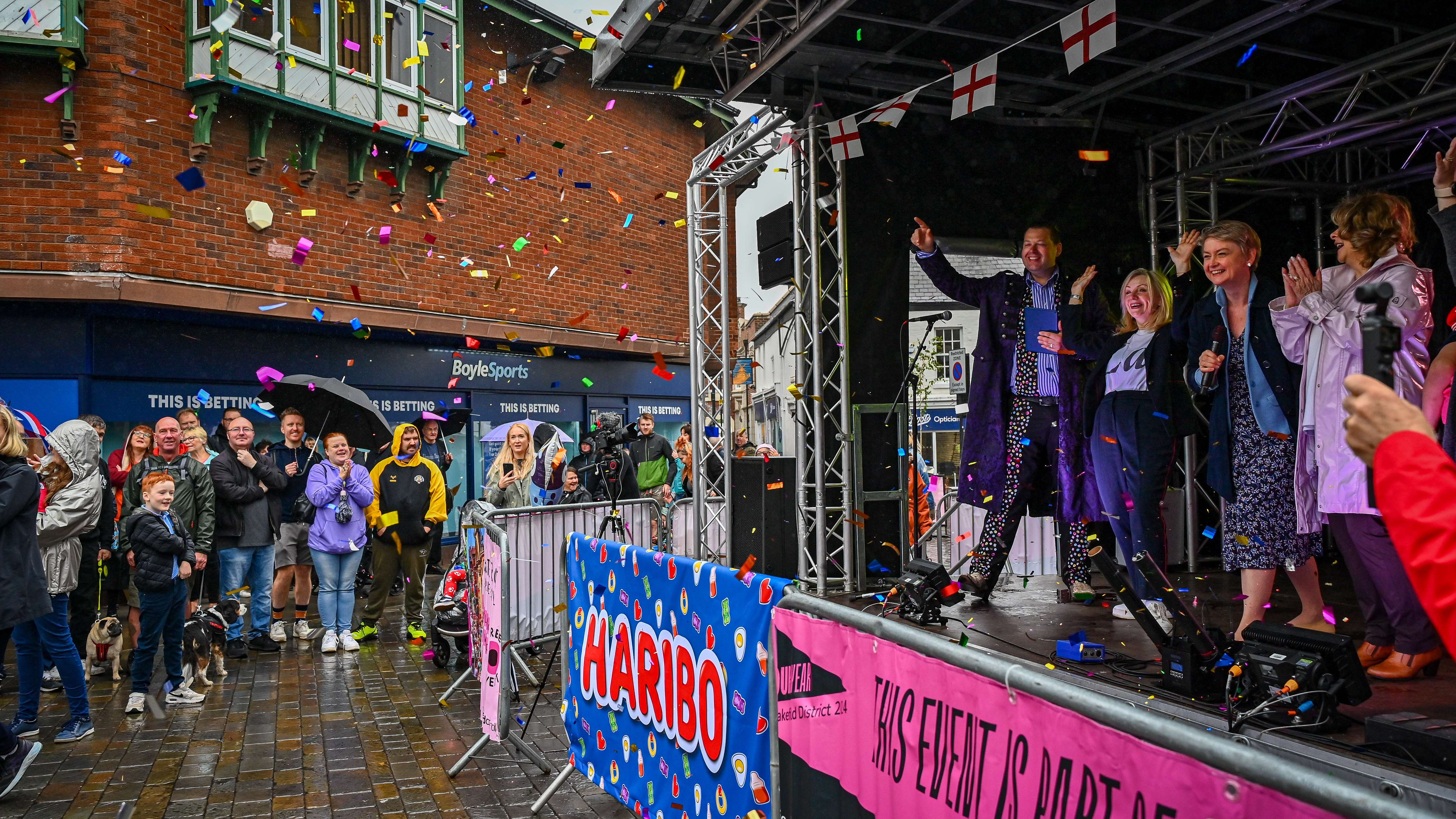 Rainy celebrations as confetti is fired off stage at the festival opening.