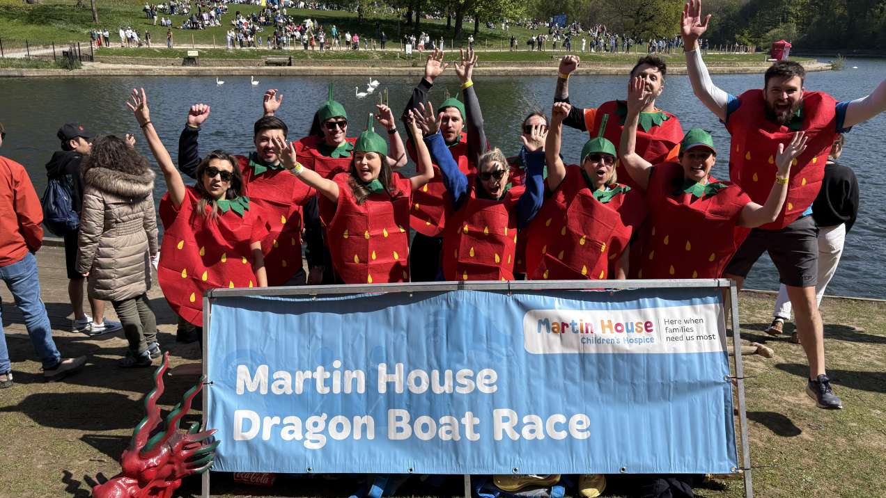 A rowing team dressed as strawberries celebrate