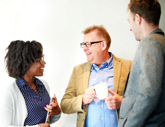 Three employees talking and laughing at HARIBO