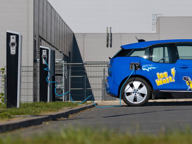 blue electric car with HARIBO branding in front of charging station