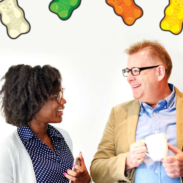 Three employees talking and laughing at HARIBO