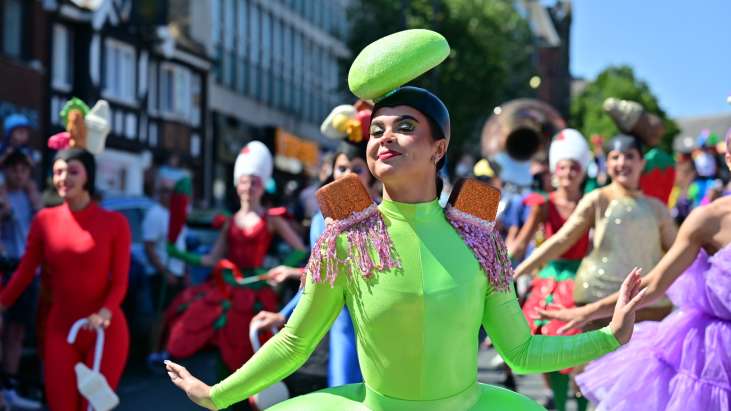 A dancer in a pear drop themed costume poses for the camera
